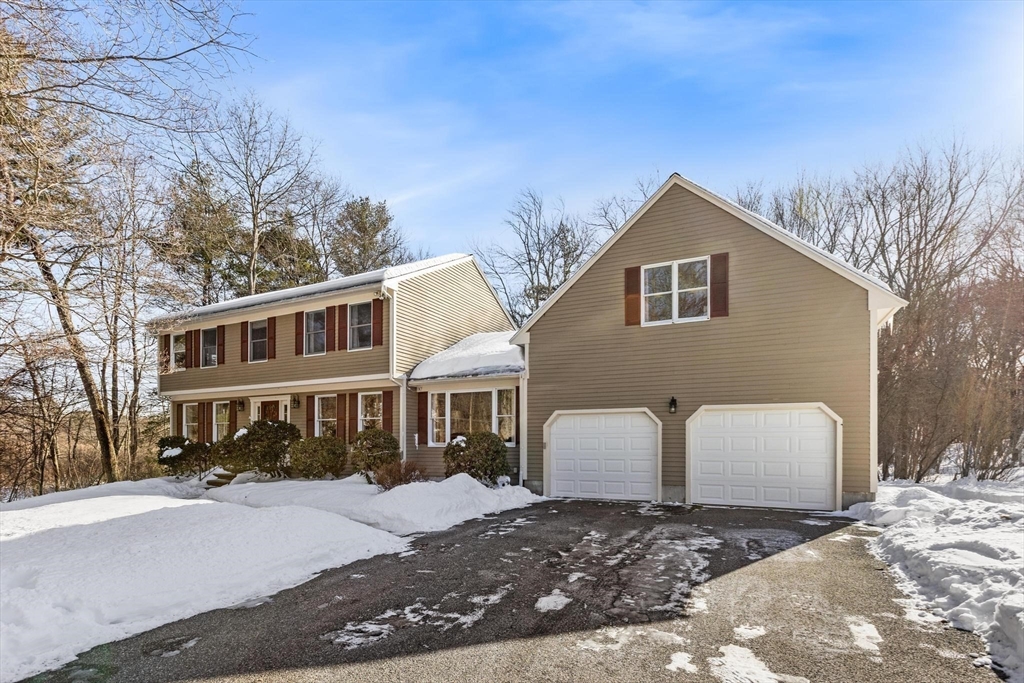 68 Sanborn Lane Reading, MA 01867 - Photo 36 of 42 a front view of a house with a yard