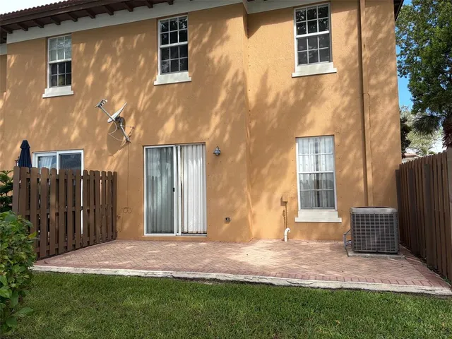 a backyard of a house with barbeque oven