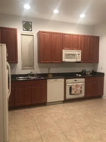 a kitchen with stainless steel appliances and cabinets