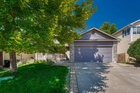 a front view of a house with a yard and a garage