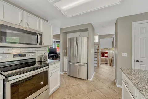 a dining room with wooden floor and windows