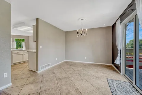 a living room with furniture a chandelier and a fireplace
