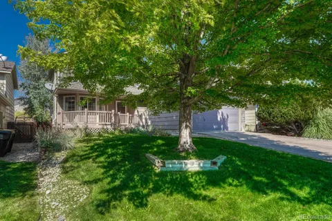 a view of a house with a yard and sitting area