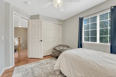 a bed sitting in a bedroom next to a window