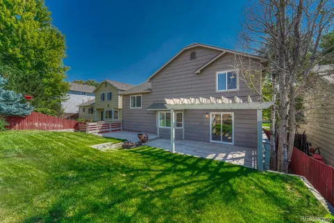 a front view of house with yard and outdoor seating