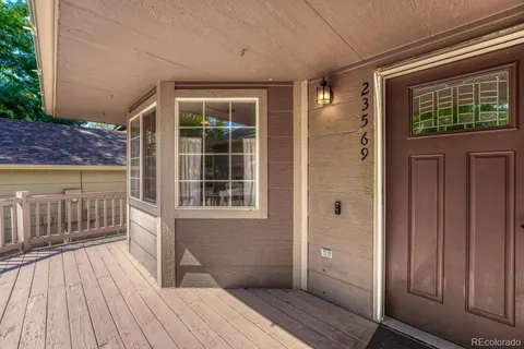 a view of a house with a barbeque and wooden floor