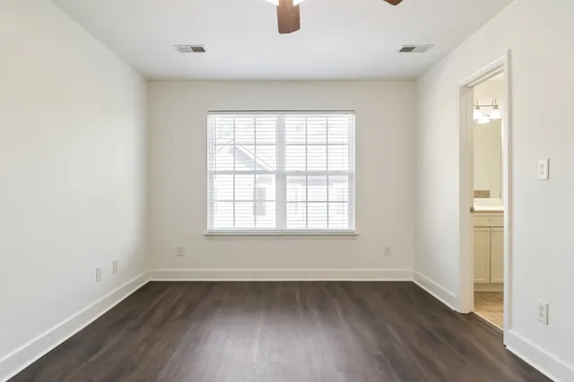 a view of an empty room with wooden floor