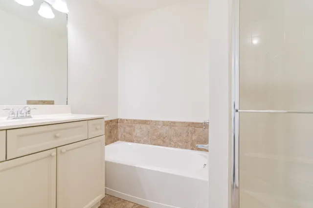 a bathroom with a glass shower door