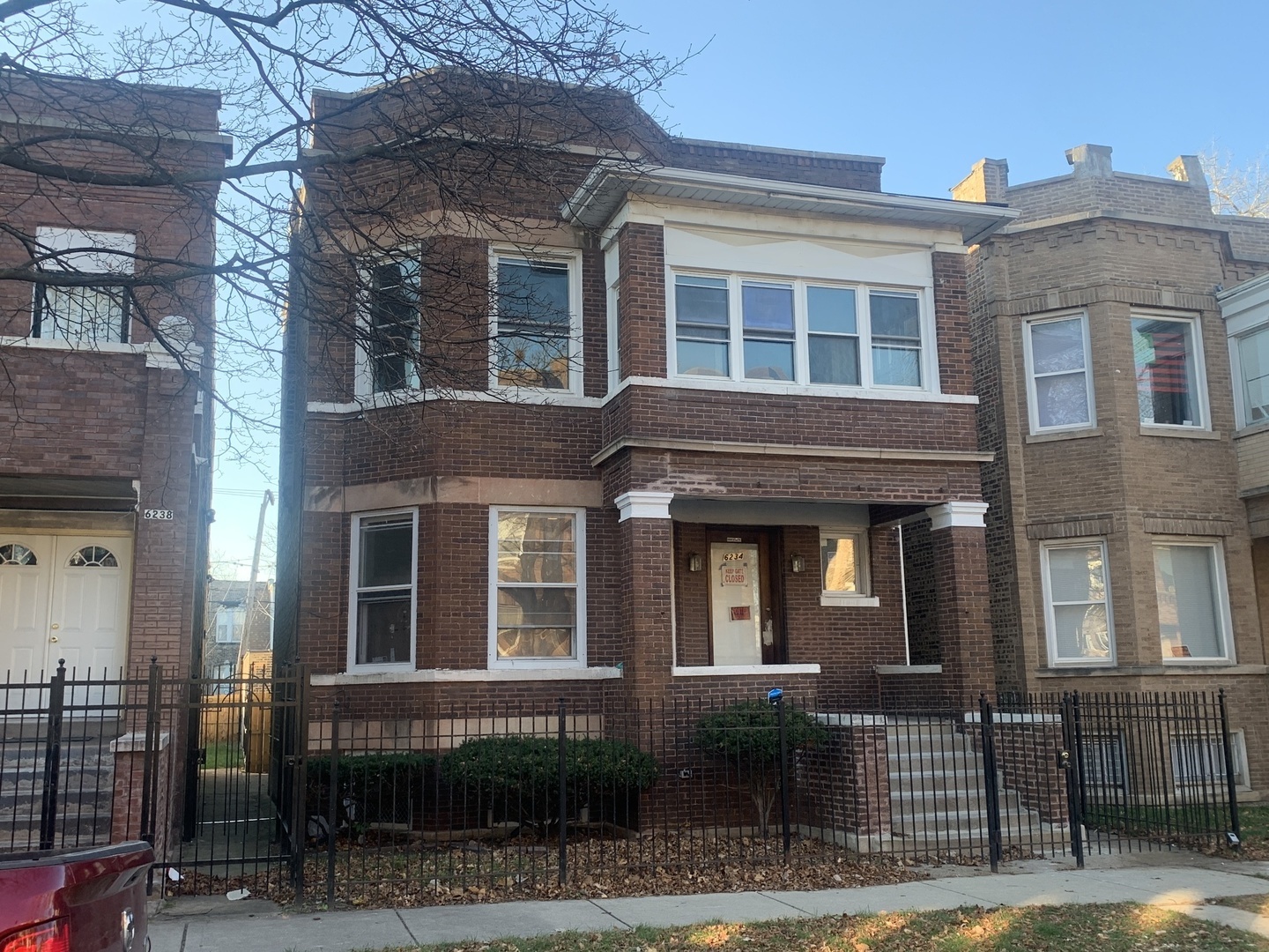 a front view of a residential apartment building with a yard