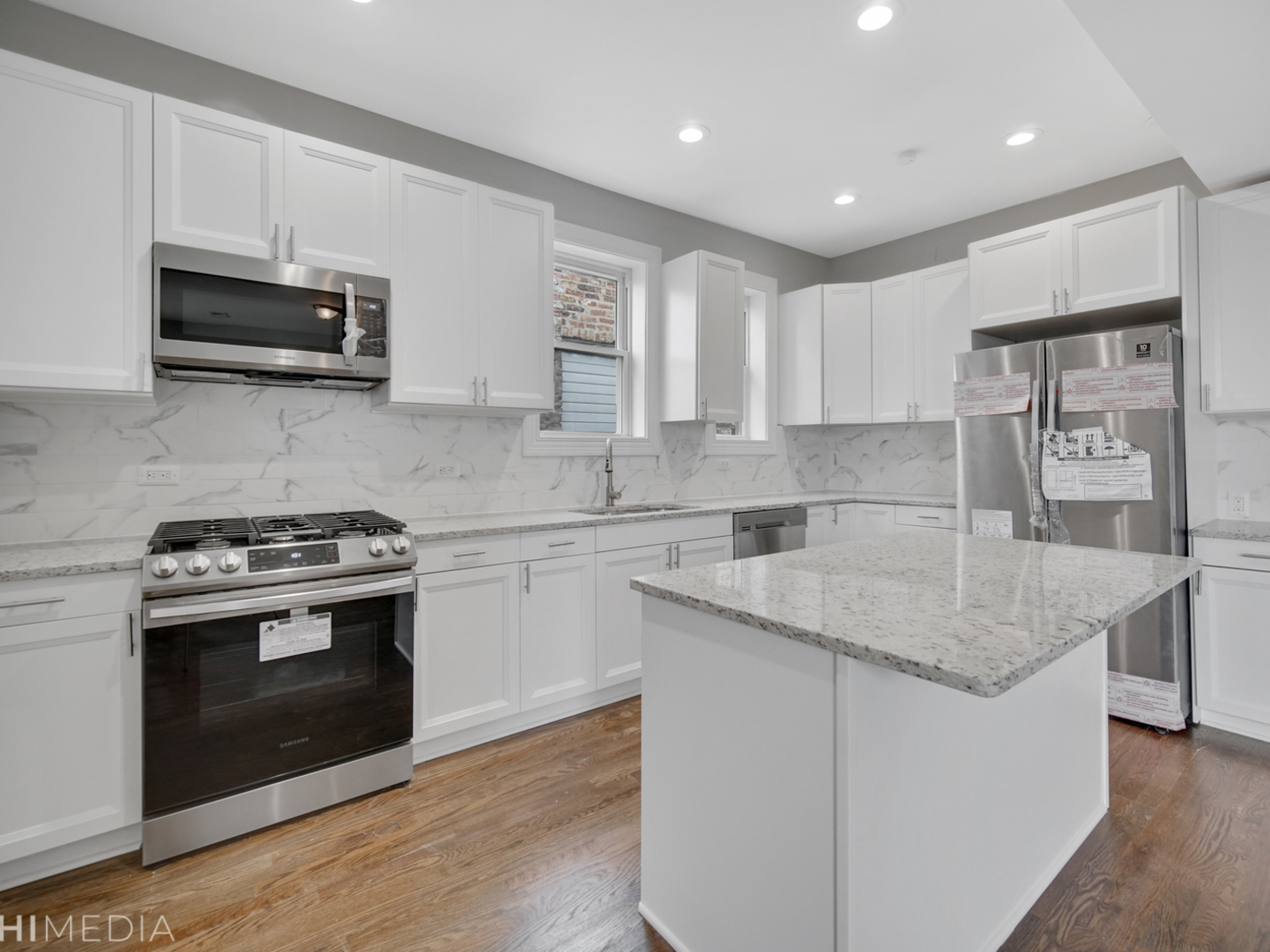 6234 South Rhodes Avenue Chicago, IL 60637 - Photo 12 of 36 a kitchen with stainless steel appliances granite countertop a sink stove and microwave