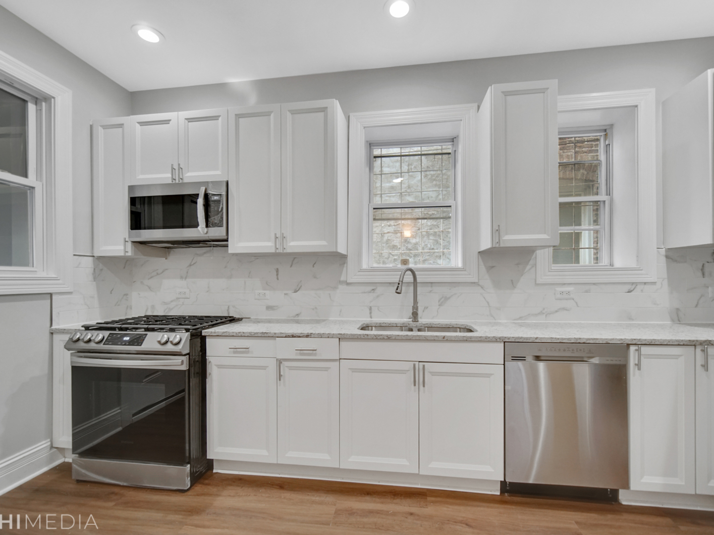 6234 South Rhodes Avenue Chicago, IL 60637 - Photo 17 of 36 a kitchen with granite countertop a stove a sink and a microwave