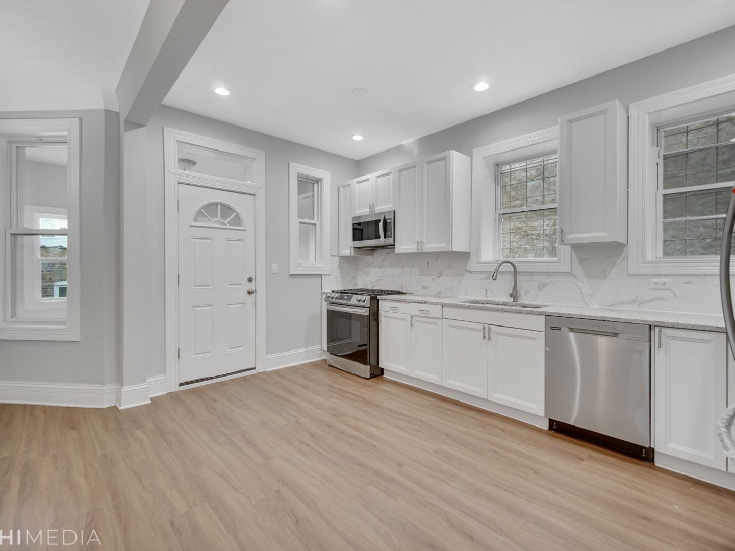 6234 South Rhodes Avenue Chicago, IL 60637 - Photo 18 of 36 a kitchen with granite countertop white cabinets and white appliances