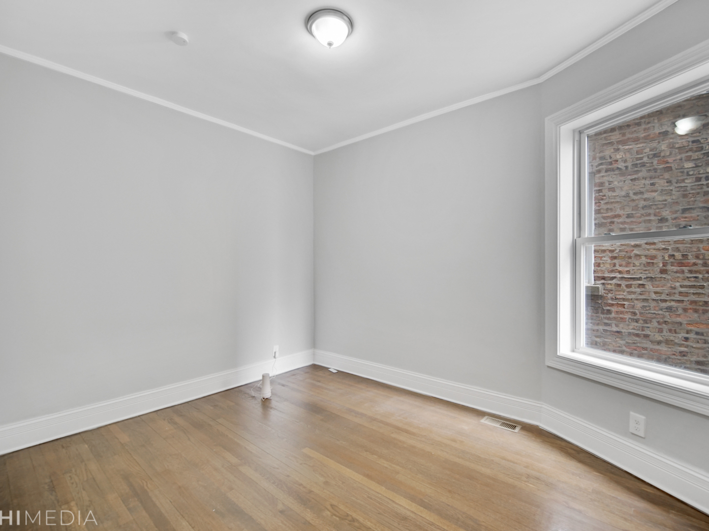 6234 South Rhodes Avenue Chicago, IL 60637 - Photo 24 of 36 wooden floor in an empty room with a window