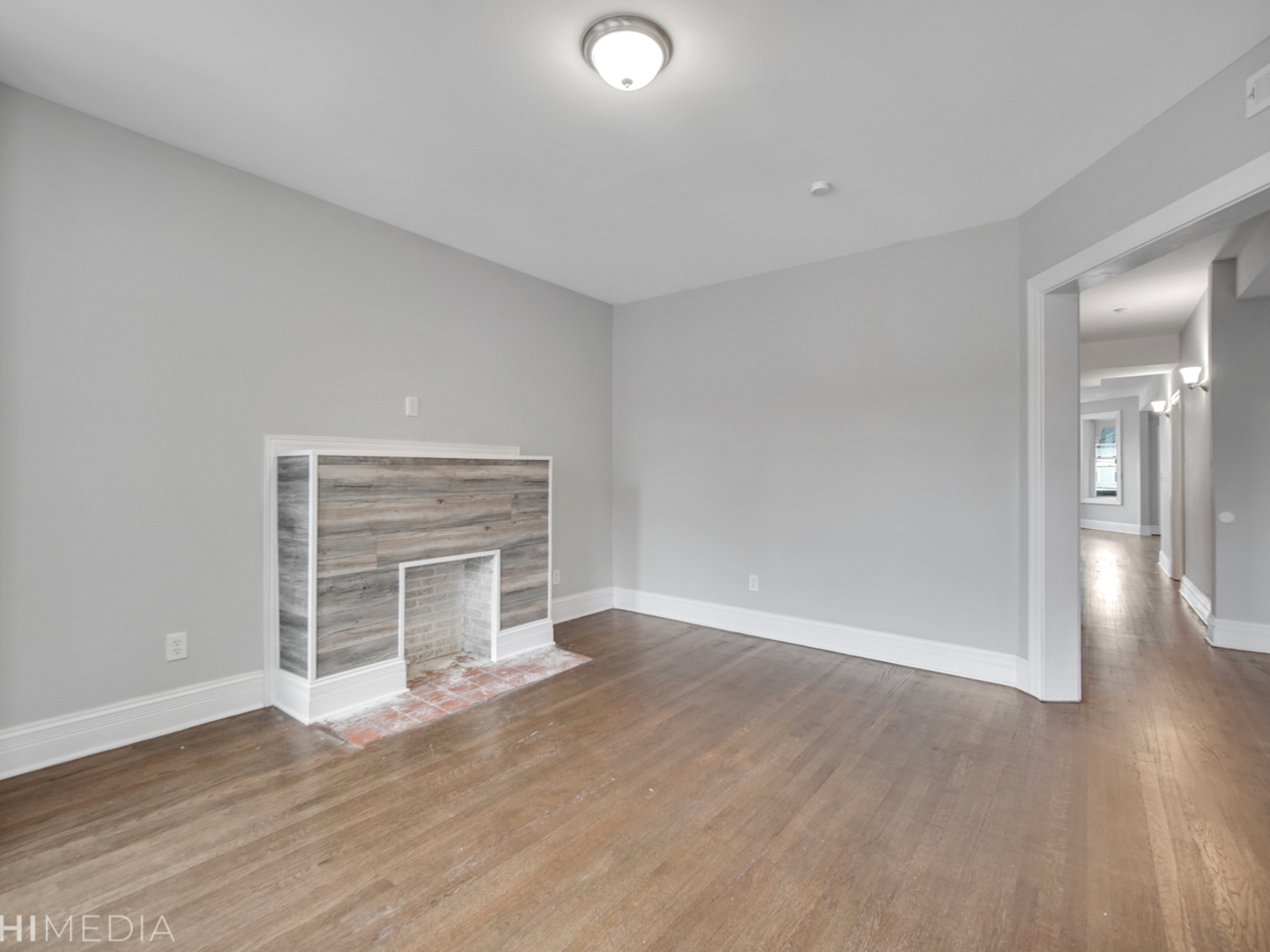 6234 South Rhodes Avenue Chicago, IL 60637 - Photo 6 of 36 a view of a livingroom with wooden floor and a fireplace