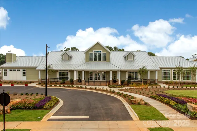 a front view of a house with swimming pool and seating space