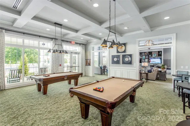 a room with pool table and windows