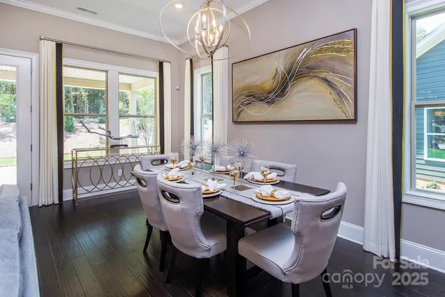 a view of a dining room with furniture wooden floor and a chandelier
