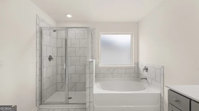 a bathroom with a bathtub and a shower
