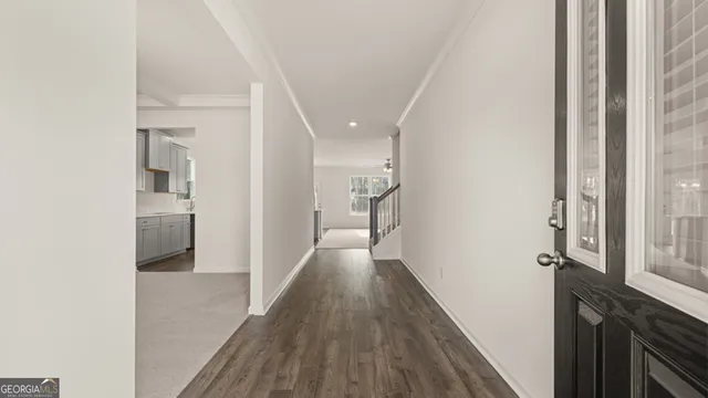a view of hallway with wooden floor