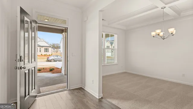 an empty room with windows and ceiling fan