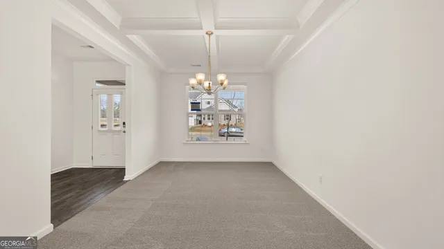 wooden floor in an empty room and a chandelier fan
