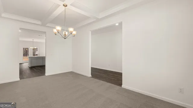a open kitchen with white cabinets and wooden floor