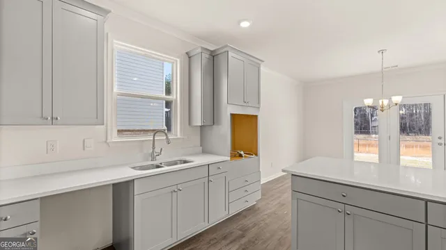 a view of a hallway with wooden floor and entryway