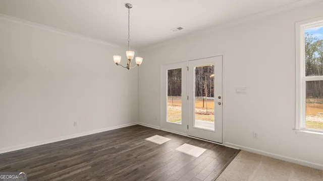 an empty room with windows and fireplace
