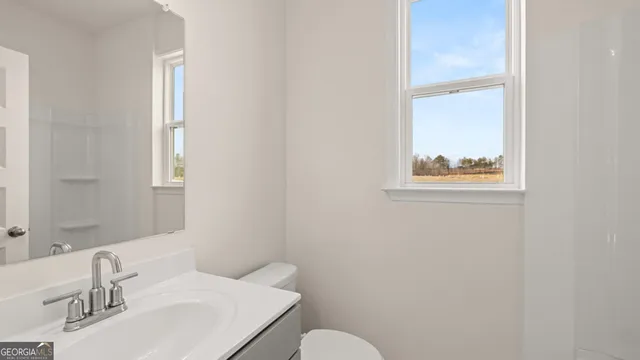 an empty room with a window and ceiling fan