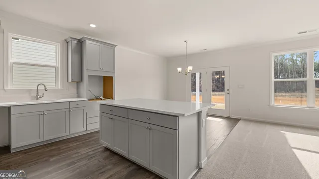 a spacious bathroom with a granite countertop sink mirror and cabinets