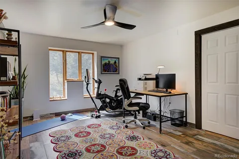 a view of a workspace with furniture and a window
