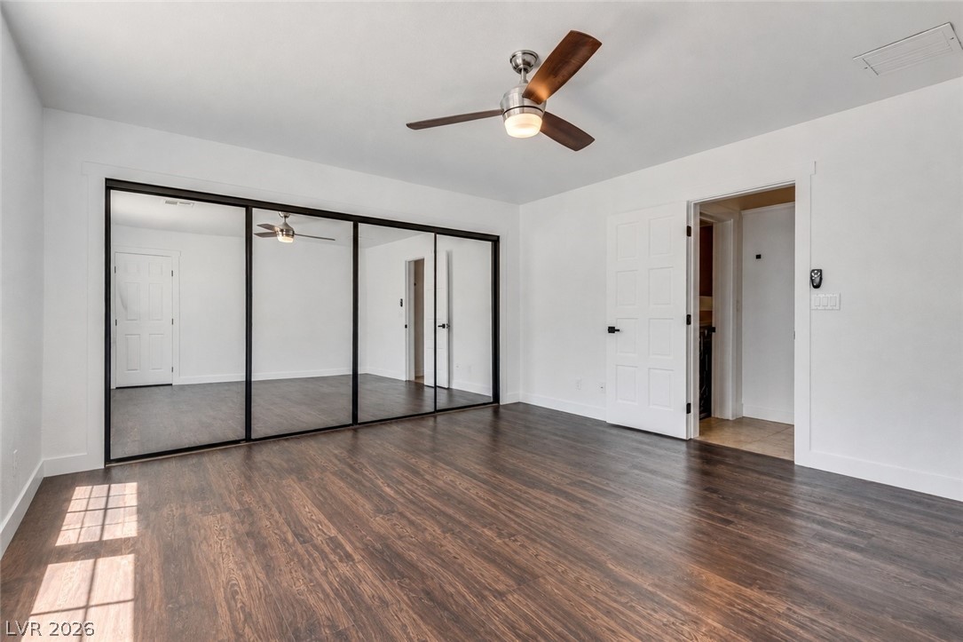 524 Swallow Cove Boulder City, NV 89005 - Photo 20 of 58 Ample closet space with mirrored doors complements the rich wood flooring in this bright bedroom.