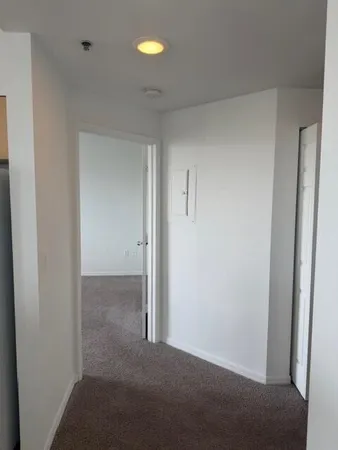 an empty room with a ceiling fan and a fan