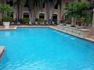a view of house with outdoor space and swimming pool