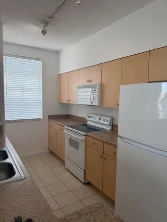 a kitchen with a refrigerator sink and stove