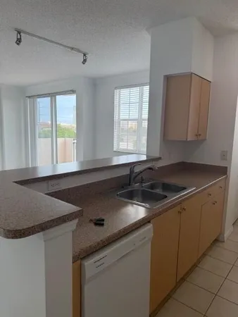 a kitchen with granite countertop a sink and a stove