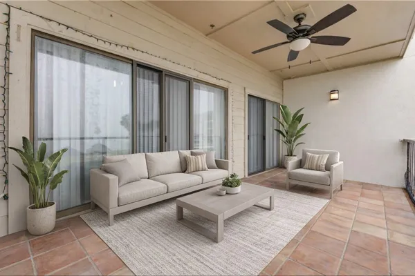 a living room with furniture and a potted plant
