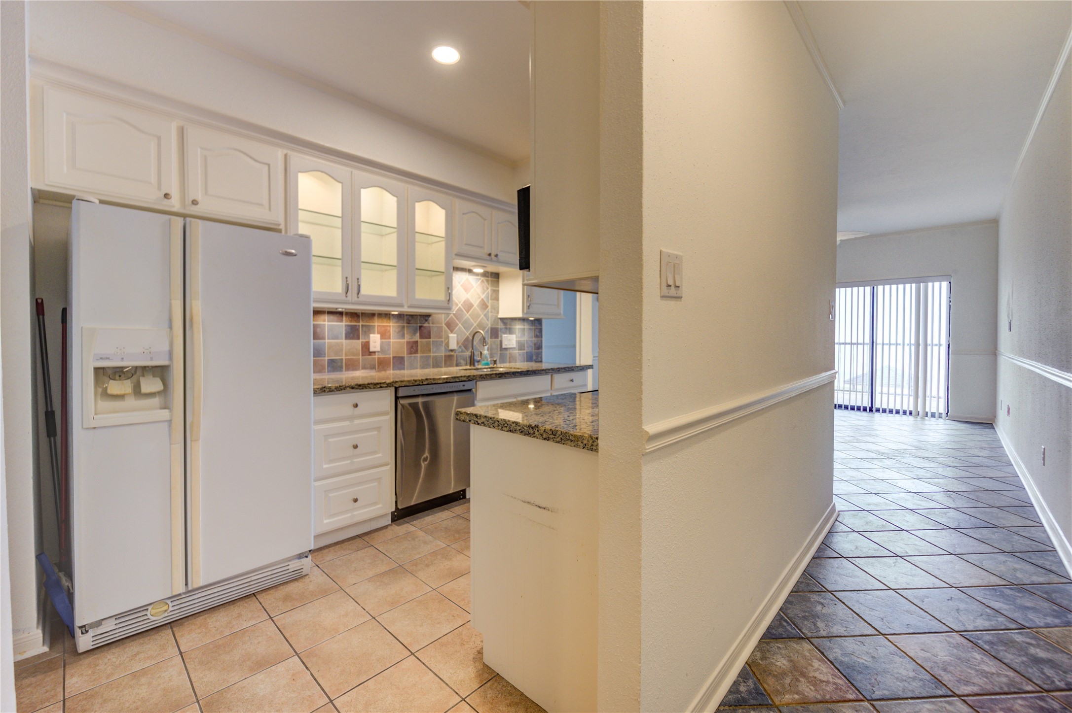 401 Lakeside Lane, Unit 106 Houston, TX 77058 - Photo 13 of 44 a kitchen with stainless steel appliances a refrigerator sink and cabinets