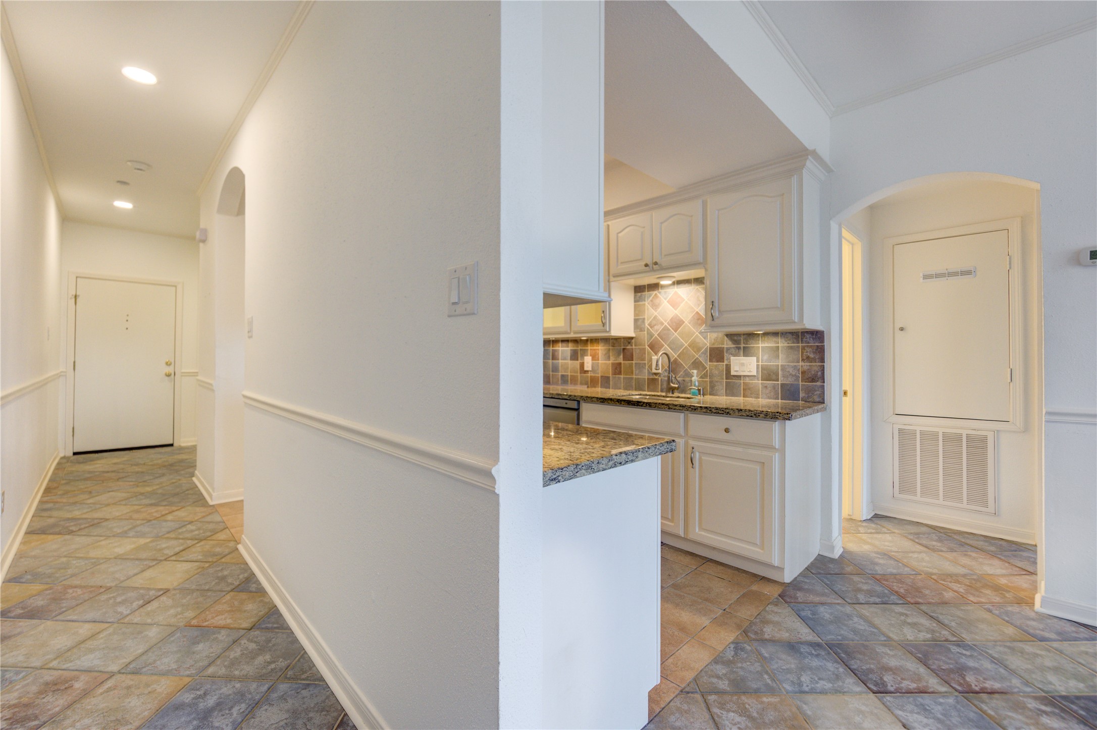 401 Lakeside Lane, Unit 106 Houston, TX 77058 - Photo 19 of 44 a kitchen with white cabinets and refrigerator
