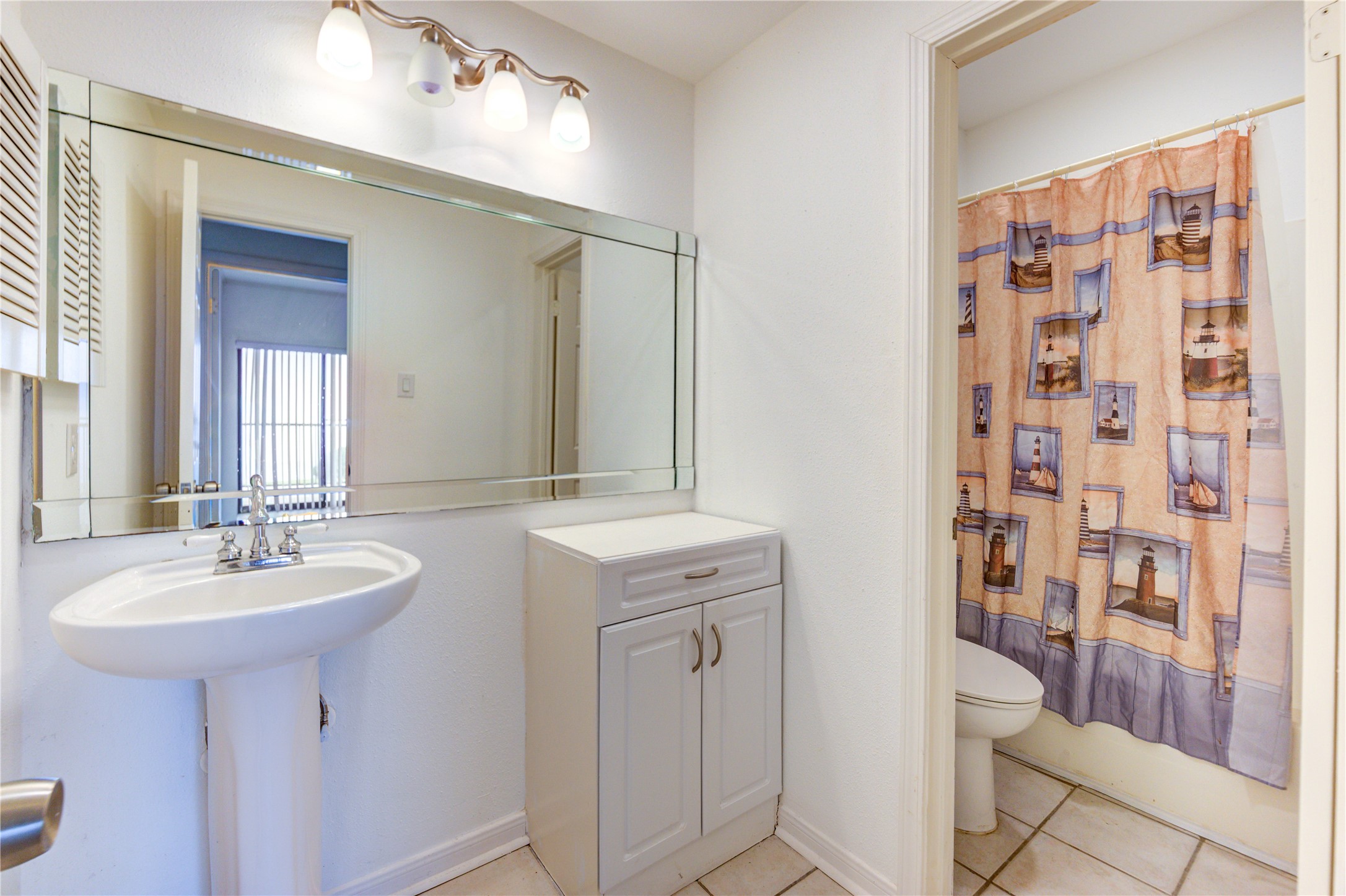 401 Lakeside Lane, Unit 106 Houston, TX 77058 - Photo 27 of 44 a bathroom with a sink a toilet and shower