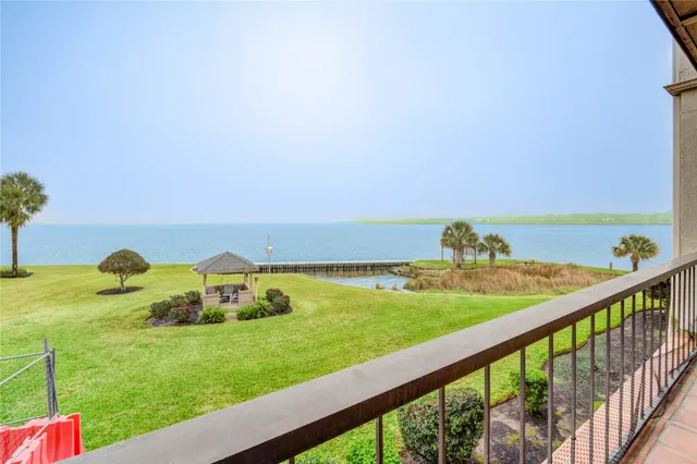 a view of a lake with houses in the back
