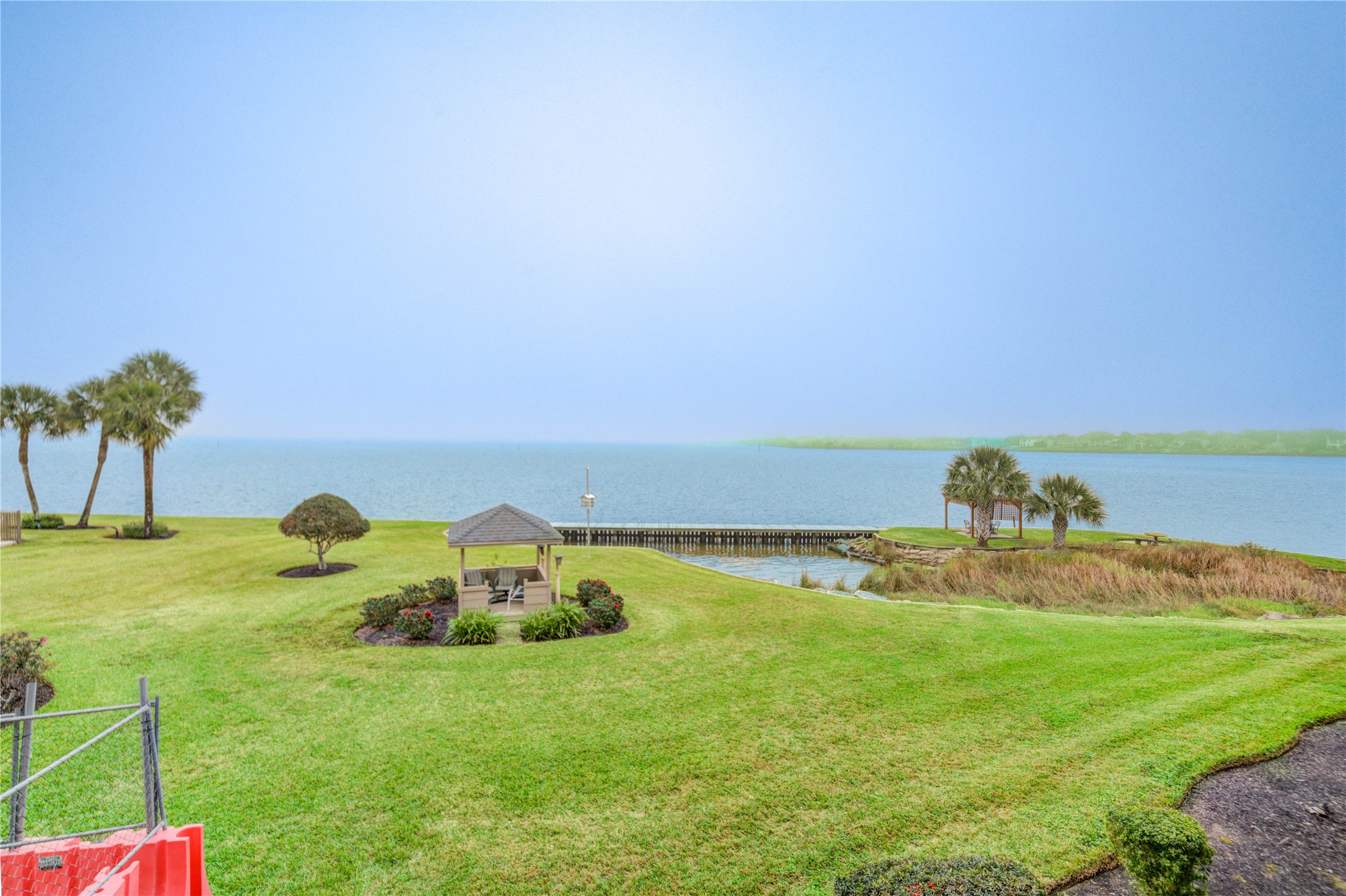 401 Lakeside Lane, Unit 106 Houston, TX 77058 - Photo 35 of 44 a view of a lake with houses in the back