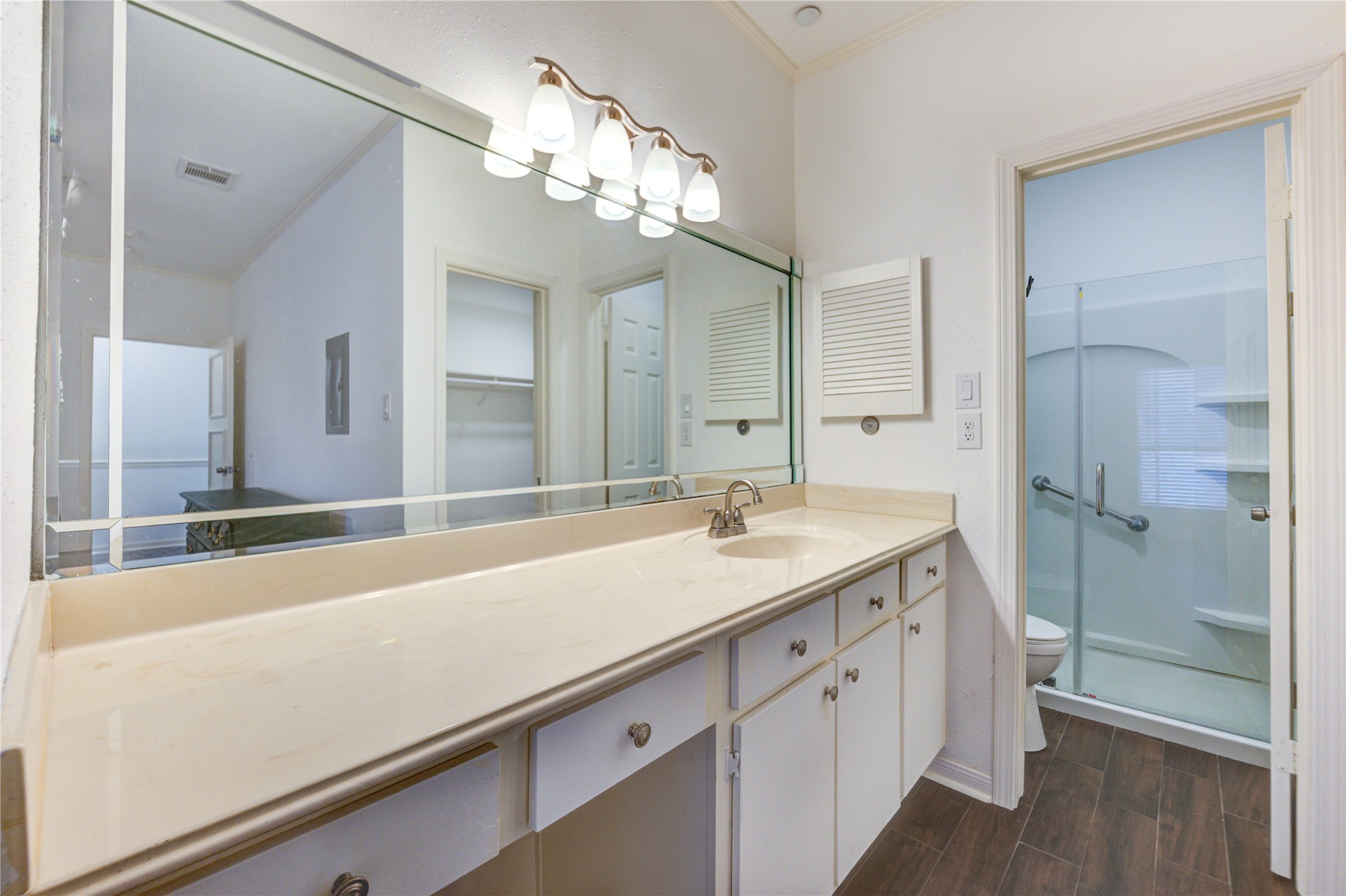 401 Lakeside Lane, Unit 106 Houston, TX 77058 - Photo 9 of 44 a bathroom with a sink a large mirror and a shower