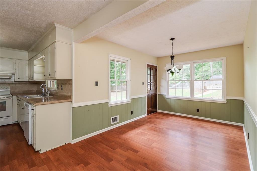 1291 Stephens Street Southwest Lilburn, GA 30047 - Photo 18 of 22 a kitchen with window and wooden floor