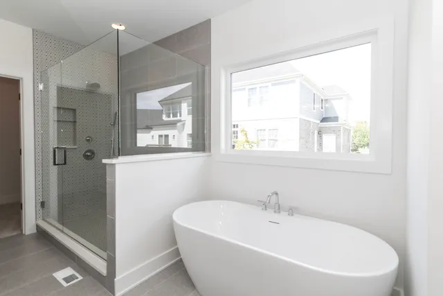 a white bath tub sitting next to a window