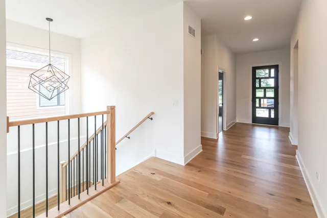 a view of a hallway with wooden floor