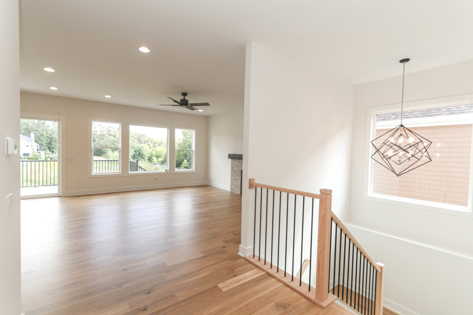 1033 Emerald Drive Naperville, IL 60540 - Photo 4 of 16 a view of a hallway with wooden floor and windows