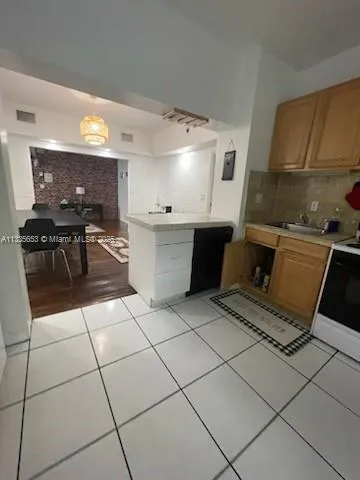 a kitchen with a sink a refrigerator and a stove