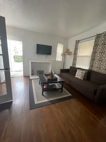 a bathroom with a sink a toilet a mirror and shower