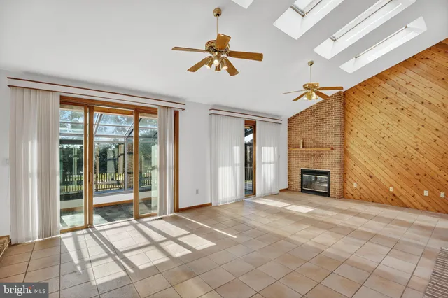 a view of an empty room with a fireplace and a window